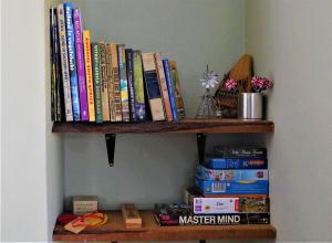 a book shelf with a bunch of books on it at Tuinhuis in Oudtshoorn