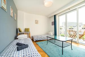 a room with two beds and a glass table at Central, Spacious, Modern 5 Bedrm duplex w/Balcony in Prague