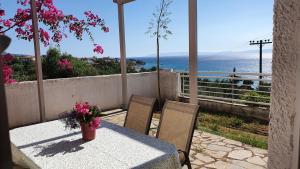 a table and chairs with a view of the ocean at Villa pinelopi in Kalamata