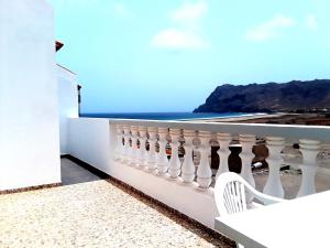 a white balcony with a view of the ocean at Pousada B&B Le Gourmet in São Pedro