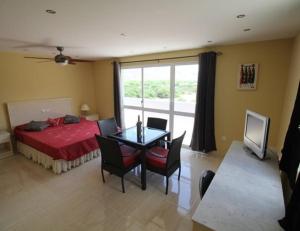 a bedroom with a bed and a table and chairs at Pousada B&B Le Gourmet in São Pedro