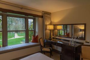 Voodi või voodid majutusasutuse BrookLodge & Macreddin Village toas