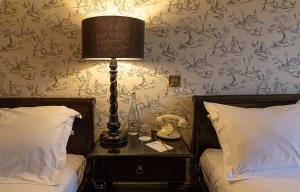 Voodi või voodid majutusasutuse BrookLodge & Macreddin Village toas