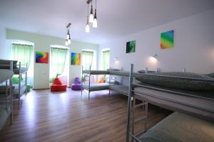 a room with three bunk beds in a room at Viva la Vida Hostel in Braşov