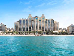 
a large body of water with tall buildings at Fairmont The Palm in Dubai
