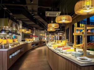 a restaurant with a buffet line with food on display at Oceanami Beach Club and Resort Long Hải in Long Hai