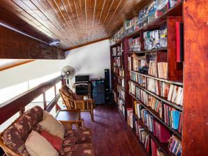 a living room with bookshelves and a couch at Black Rock Lodge in Port Edward