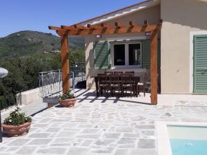 a patio with a table and chairs on a house at VILLETTA SANTA LUCIA in Marina di Campo