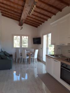 a kitchen and dining room with a table and chairs at VILLETTA SANTA LUCIA in Marina di Campo