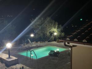 a swimming pool at night with lights at VILLETTA SANTA LUCIA in Marina di Campo