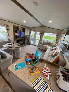 a living room with a couch and a table at Dreams Luxury Residence in Tattershall