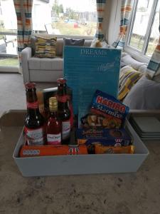 a tray filled with beer and snacks on a couch at Dreams Luxury Residence in Tattershall