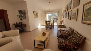 a living room with a couch and chairs and a table at Casa Cosquin in Cosquín