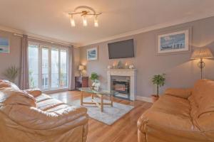 a living room with a couch and a fireplace at Town Square Townhouse - Best Location in Galway in Galway