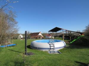 a large inflatable pool in a grassy yard at Lalot gîte in Oulches
