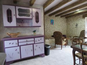 a room with a dresser and a table and chairs at Lalot gîte in Oulches