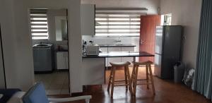 a kitchen with a counter and a refrigerator at Pomegranate Selfcatering apartment in Nelspruit