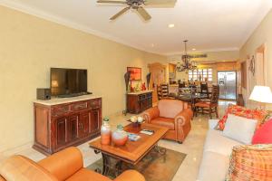 a living room filled with furniture and a flat screen tv at Cabo La Estancia in Cabo San Lucas