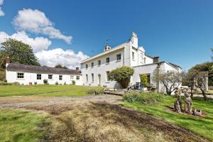 an exterior view of a large white house at Beachborough Park in Folkestone