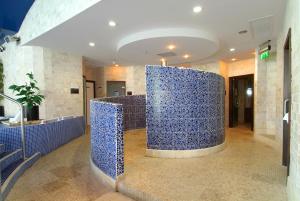 een lobby met een blauwe tegelmuur in een gebouw bij BrookLodge & Macreddin Village in Aughrim