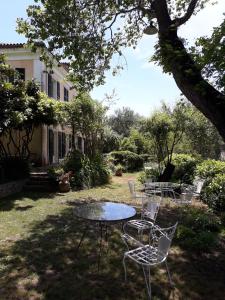 uma mesa e cadeiras no quintal de uma casa em Villa Kefalomandouko em Corfu Town