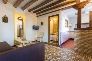 a living room with a fireplace and a bedroom at Carmen Vistas de la Alhambra in Granada