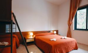 a bedroom with a bed with two white cats on it at Hotel Almas in Capaccio-Paestum