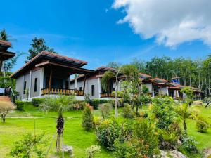 a house with a garden in front of it at Phurin Thara Resort in Ko Lanta