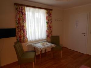 a dining room with a table and chairs and a window at Haus Amalia in Strobl