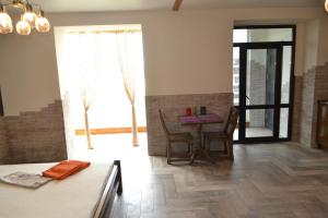 a living room with a table and a window at Апартаменты ПРЕМЬЕР in Kamianets-Podilskyi +9 photos