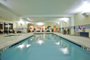 a large swimming pool with blue water at Holiday Inn Express Hotel Raleigh Southwest, an IHG Hotel in Raleigh
