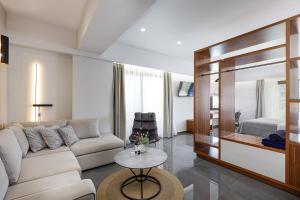 a living room with a couch and a table at Sea View Suite "Hara" - Adults Only in Plakias