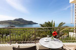 a table on a balcony with a view of the ocean at Artemis Exclusive Double Sea View Adults Only in Plakias