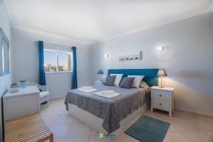 En eller flere senger på et rom på Vila da Praia - Apartamento Viva Local
