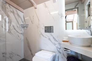 a bathroom with a sink and a toilet at Lilian Loft Sea View - Adults Only in Plakias