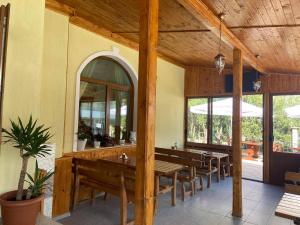 a dining room with wooden tables and benches at Hotel Margarita in Kranevo