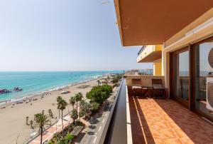 a balcony with a view of a beach and the ocean at Los Reales 8B in Estepona