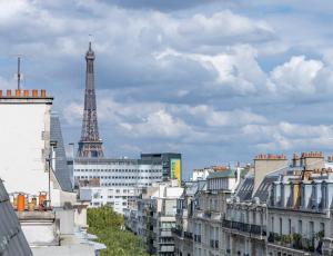 een stad met de eiffeltoren op de achtergrond bij MaisondesChaumes-Paris in Parijs