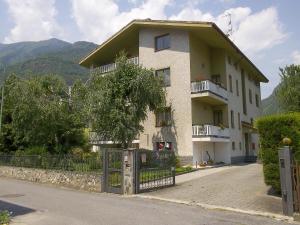 a white house with a fence in front of it at B&B da Lori in Tirano