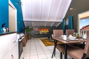 a kitchen with a table and chairs and a fireplace at CityLife Apartments in Historic Willemstad - 2 bedroom apartment - K in Willemstad