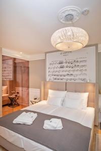 a bedroom with a bed with two towels on it at Heritage Villa Nobile in Dubrovnik