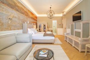 a hotel room with a bed and a couch at Heritage Villa Nobile in Dubrovnik