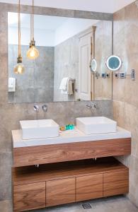 a bathroom with two sinks and a mirror at Heritage Villa Nobile in Dubrovnik +37 photos