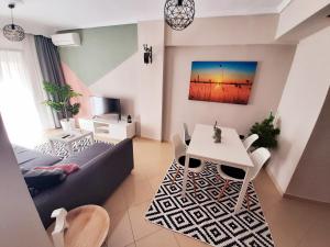 a living room with a couch and a table at Sweet Apartment in Thessaloniki