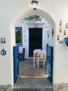 an archway leading to a patio with a table and a door at Denizati Pension in Bodrum City