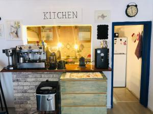 a kitchen with a counter with a kitchen sign on the wall at Denizati Pension in Bodrum City +20 photos