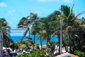a view of a beach with palm trees and the ocean at ARTE FLATS in Fortaleza