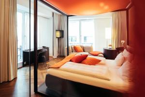 
a hotel room with a large bed and a large window at Hollmann Beletage Design & Boutique Hotel in Vienna
