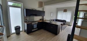 a kitchen with a sink and a stove top oven at LFA La petite maison du coin in Flémalle-Grande