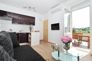 a living room with a couch and a table at Lavanda in Poljana